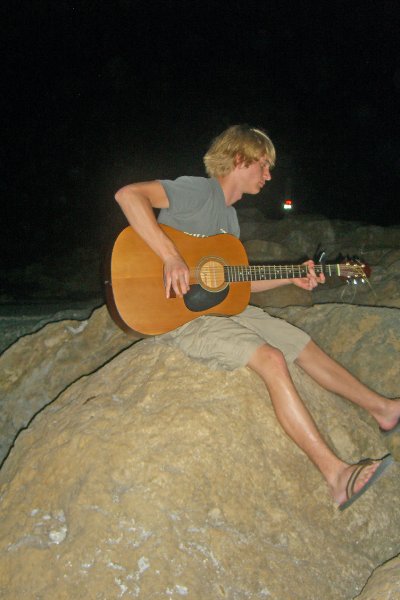 CIMG8326_edited-1.jpg - Mike on the beach at Redfish Pass, playing guitar