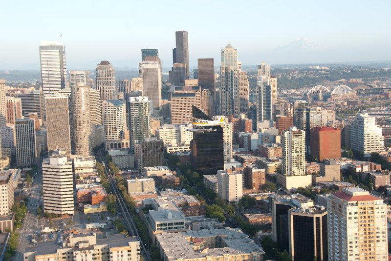 Seattle080309-8356.jpg - Airplane Flying Across Downtown Seattle Skyline as viewed from the SE side of the Space Needle