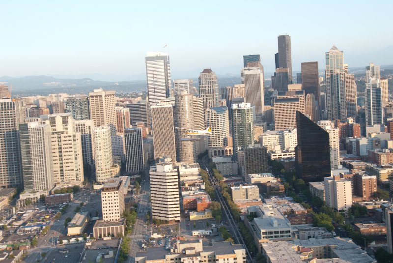 Seattle080309-8357.jpg - Airplane Flying Across Downtown Seattle Skyline as viewed from the SE side of the Space Needle