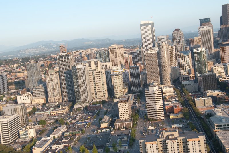 Seattle080309-8358.jpg - Airplane Flying Across Downtown Seattle Skyline as viewed from the SE side of the Space Needle