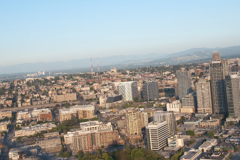 Seattle080309-8365.jpg - Airplane Flying Across Downtown Seattle Skyline as viewed from the SE side of the Space Needle