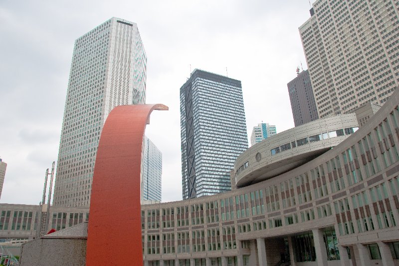 Tokyo051109-6638.jpg - Tokyo Metropolitan Assembly Bldg, Orange Steel Sculpture, Shinjuku Sumitomo Bldg (center left background), Shinjuku Mitsui Bldg (6Xs), Keio Plaza Hotel (upper right edge)